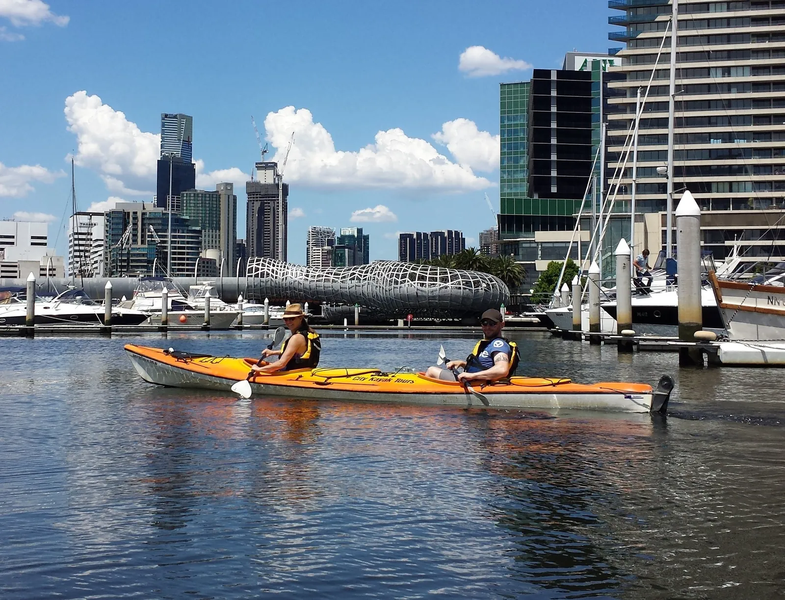Kayakers paddling past the Docklands towers
