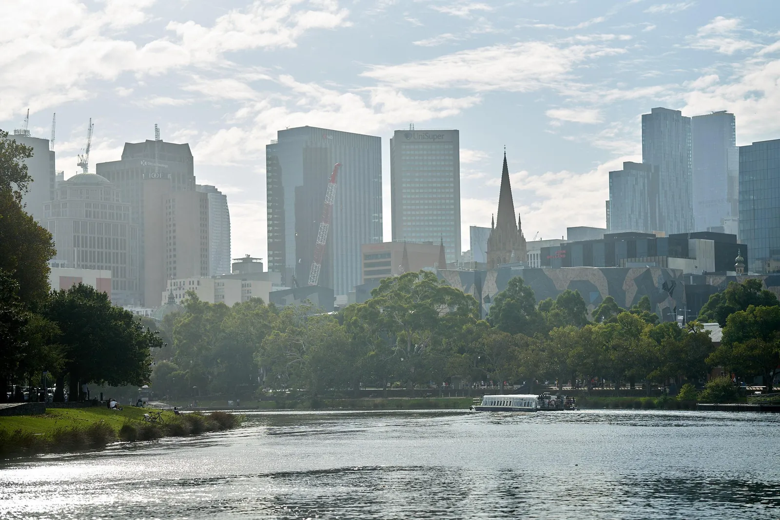 Melbourne's city towers above riverside trees on the Yarra